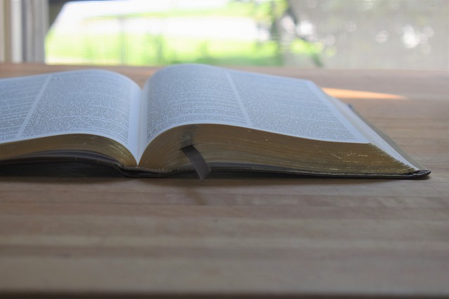 New Years Resolution - Keep Your Bible Open and Handy. Bible open on a wooden table.
